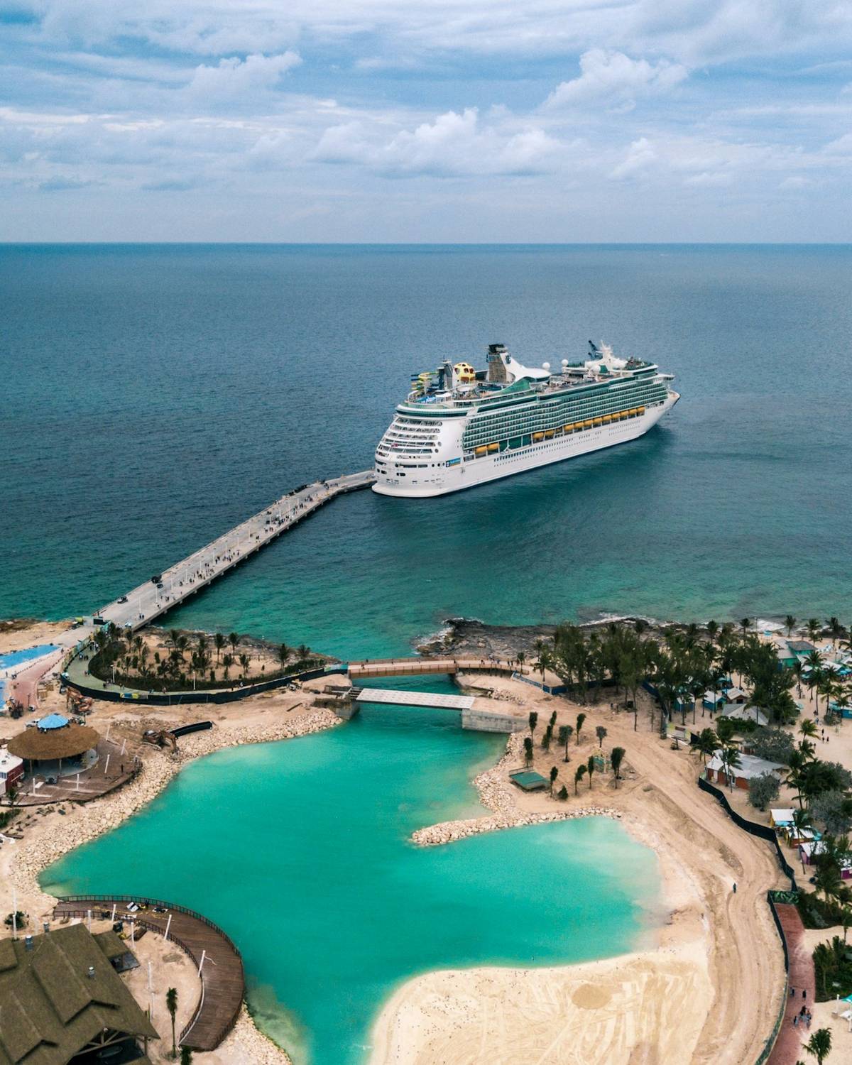 Cruise ship beside a turquoise island lagoon